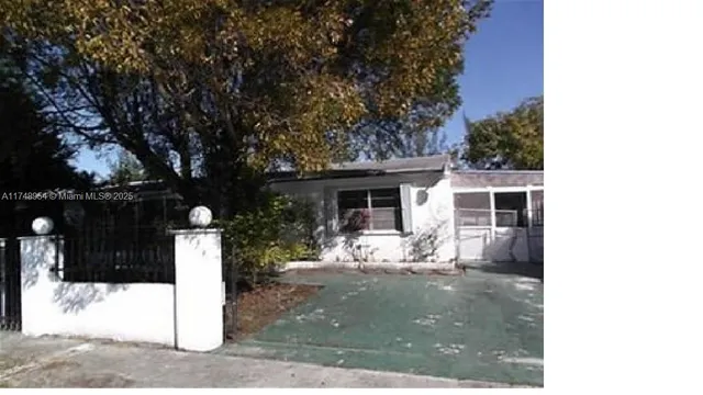 a view of a house with yard and sitting area