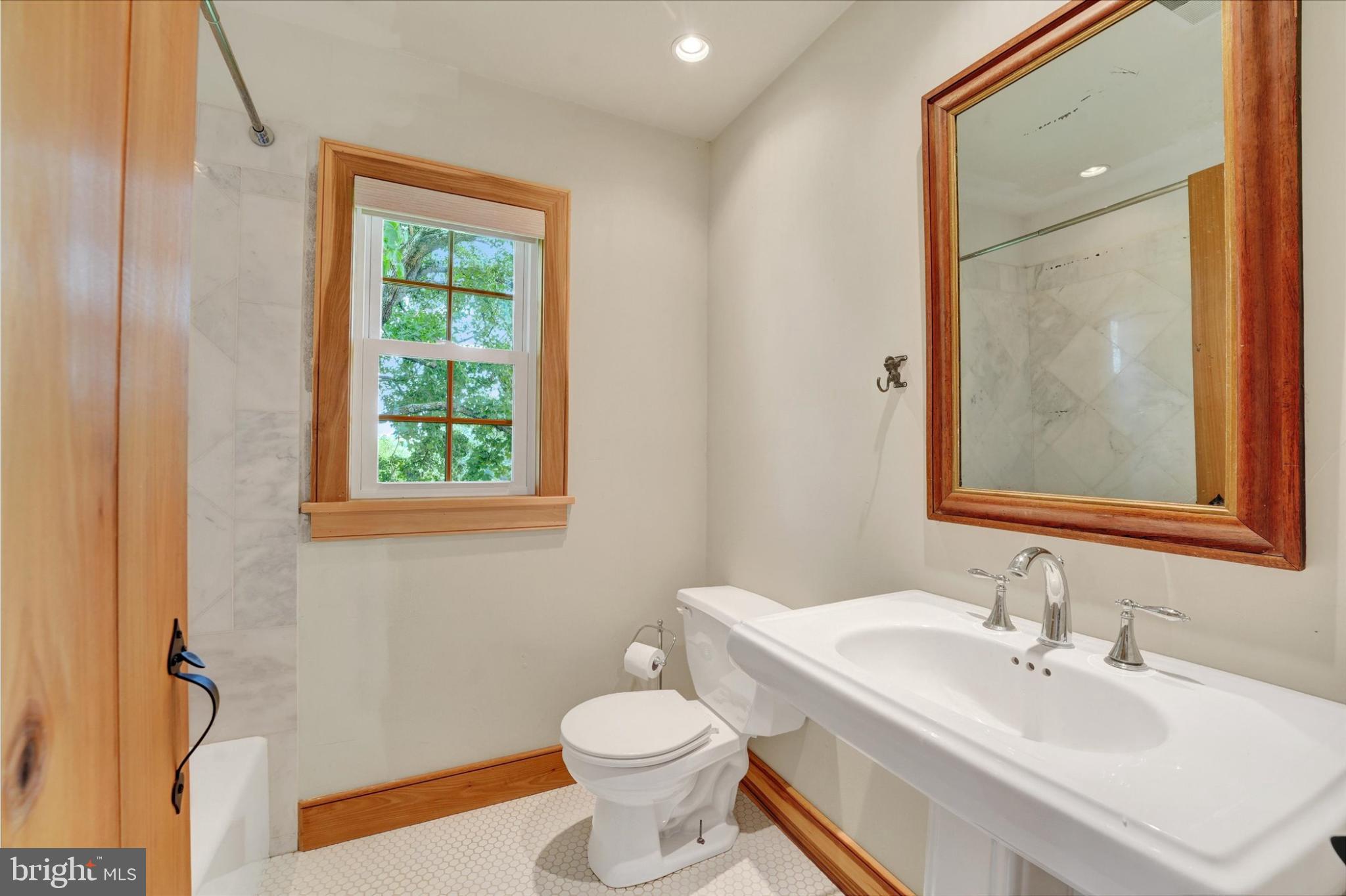 180 Springdell Road Coatesville, PA 19320 - Photo 21 of 55 a bathroom with a toilet a sink and a mirror