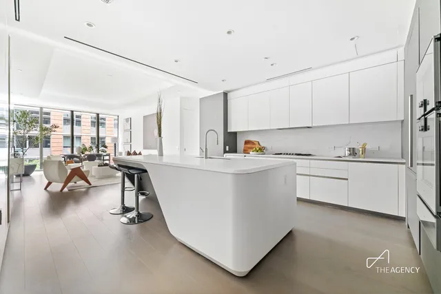 a kitchen that has a lot of cabinets in it and appliances