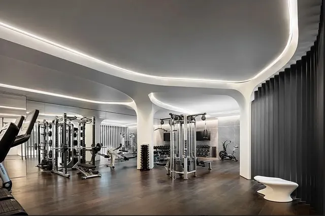 a room with gym equipment and a view of living room