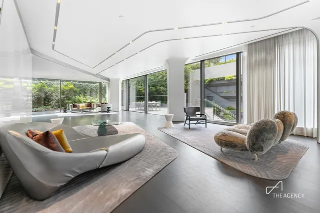 a view of a dining room with furniture large windows and wooden floor