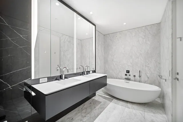 a bathroom with a double vanity sink and a mirror