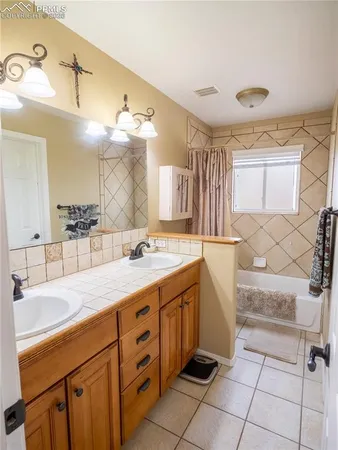 a spacious bathroom with a sink and a mirror