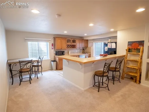 a kitchen with a table and chairs in it