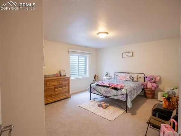 a bedroom with furniture and window