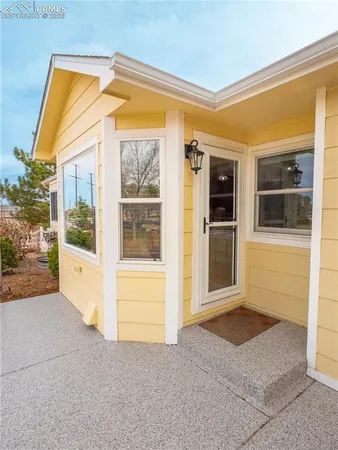 a view of front door and a yard