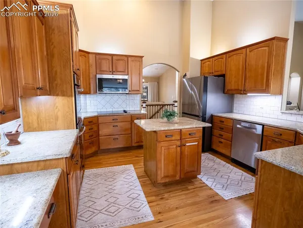 a kitchen with stainless steel appliances granite countertop a sink stove and cabinets