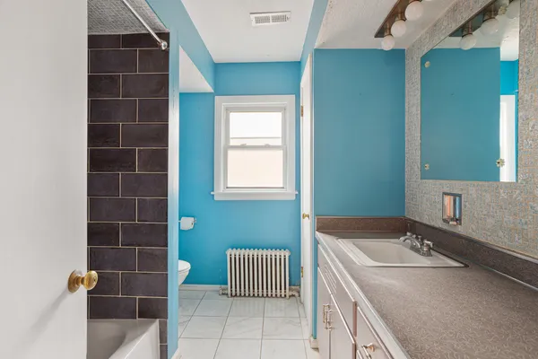 a bathroom with a sink toilet and tub