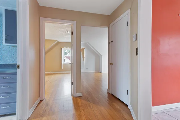 a view of a hallway with wooden floor