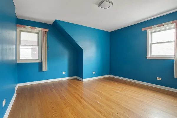 a bedroom with window and pillar