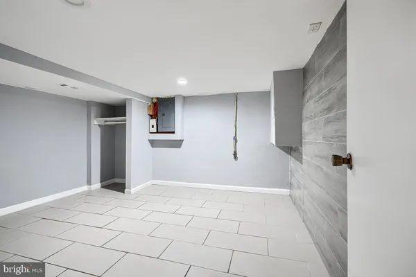 a backyard of a house with large trees and brick walls