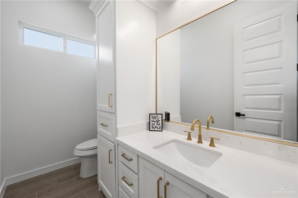 505 Freedom Way Weslaco, TX 78596 - Photo 13 of 20 a bathroom with a granite countertop sink toilet and mirror