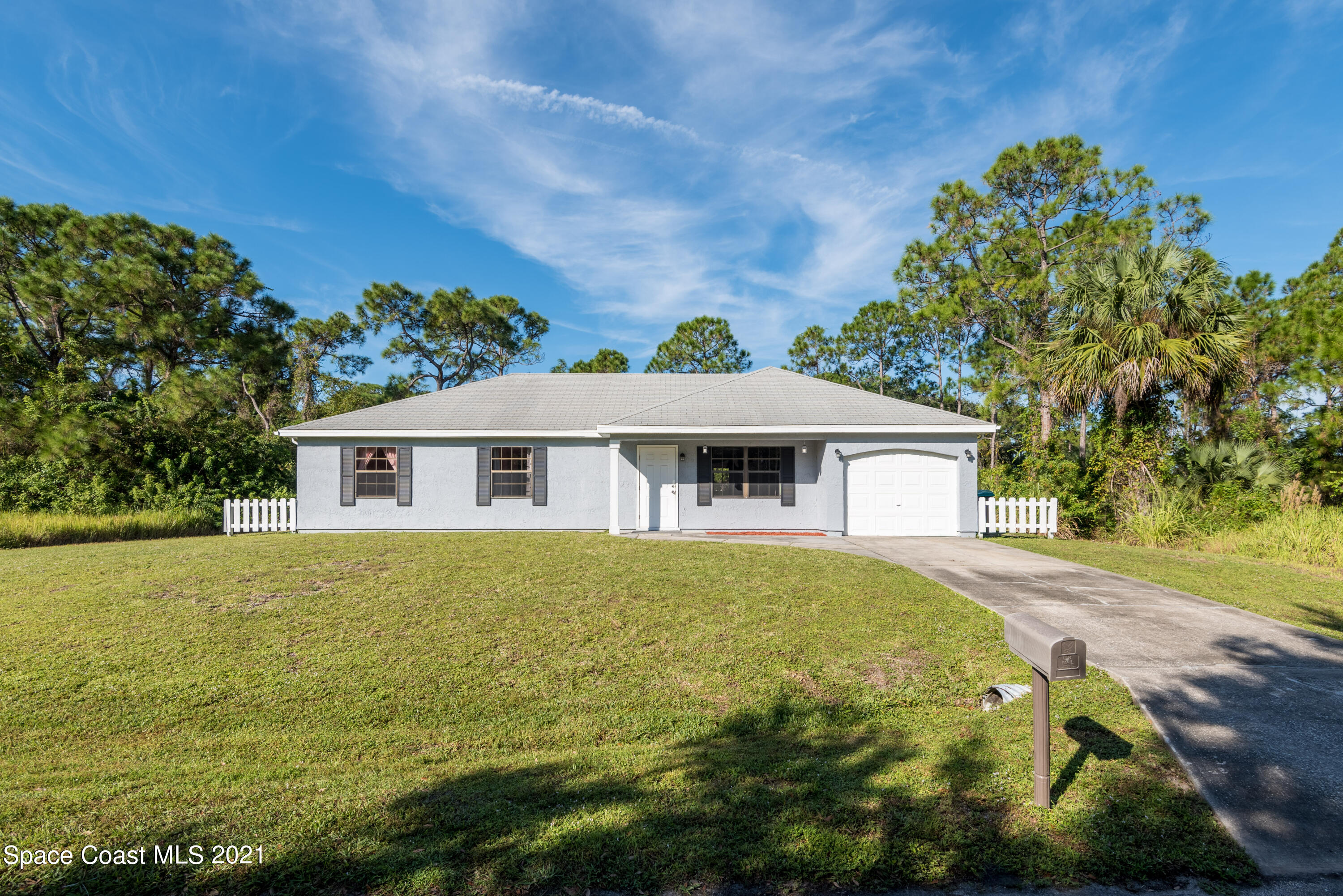 1077 San Rafael Road Southwest Palm Bay, FL 32908 - Photo 1 of 13 a view of a house with a yard