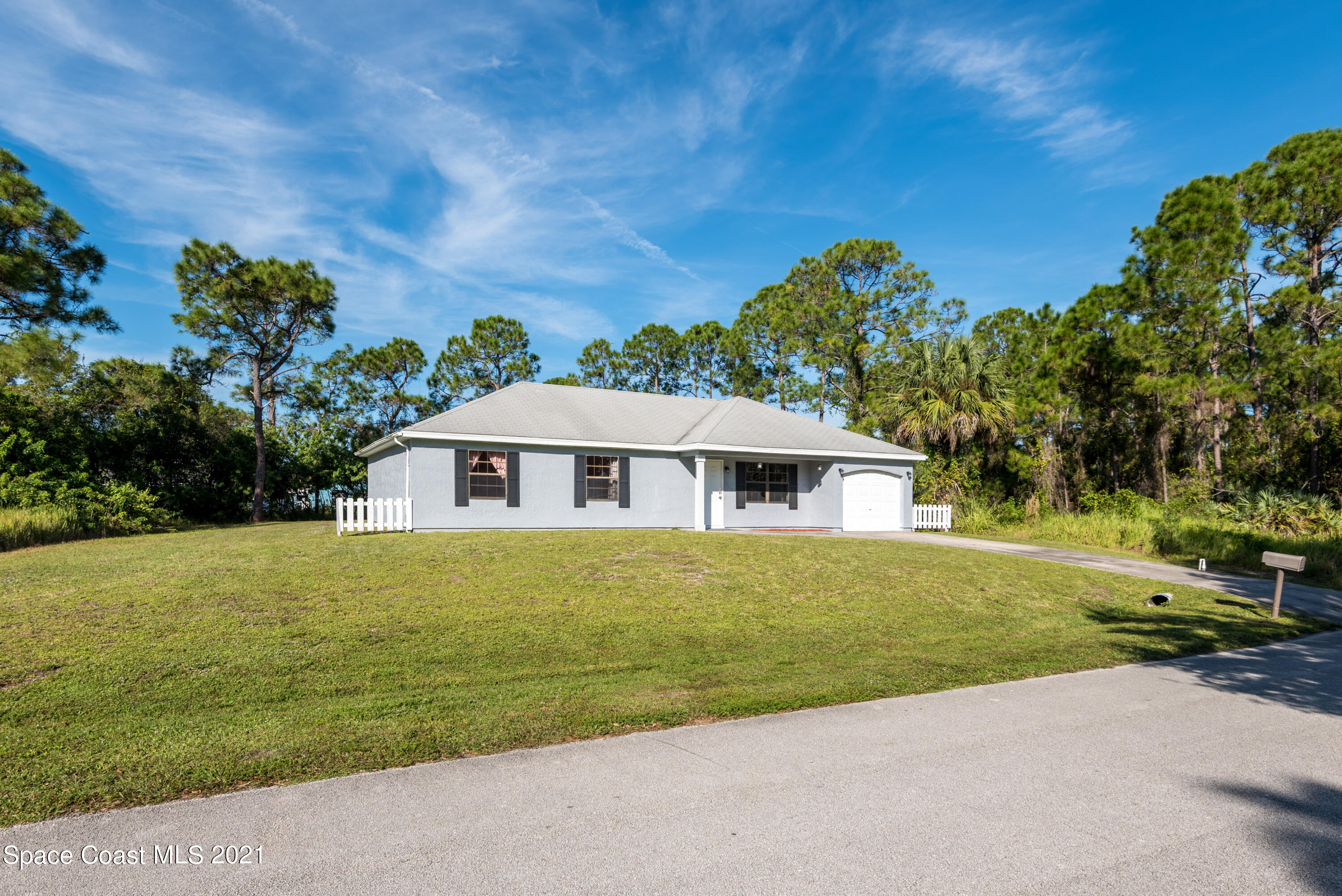 1077 San Rafael Road Southwest Palm Bay, FL 32908 - Photo 13 of 13 a front view of a house with a garden