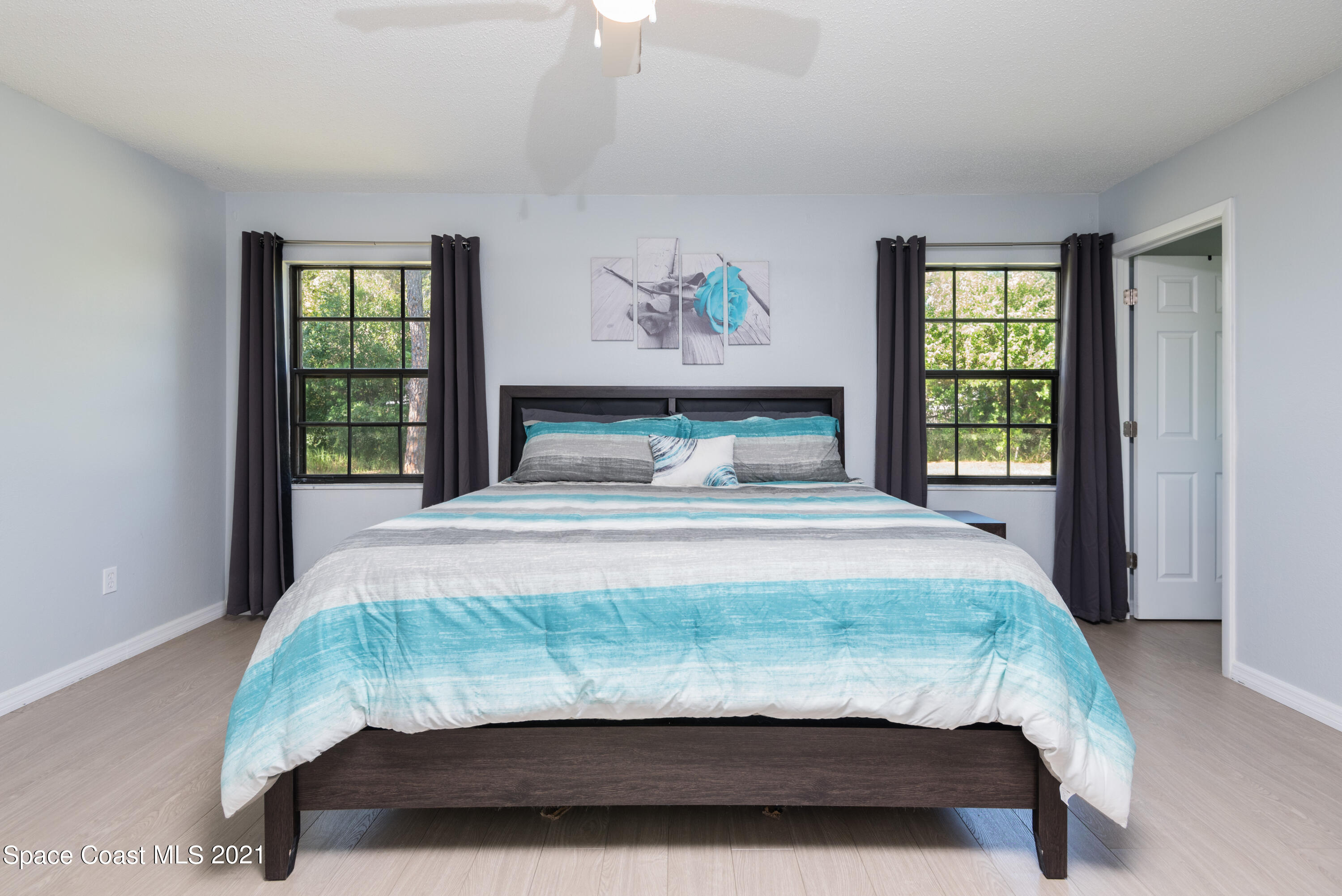 1077 San Rafael Road Southwest Palm Bay, FL 32908 - Photo 6 of 13 a bedroom with a bed and window