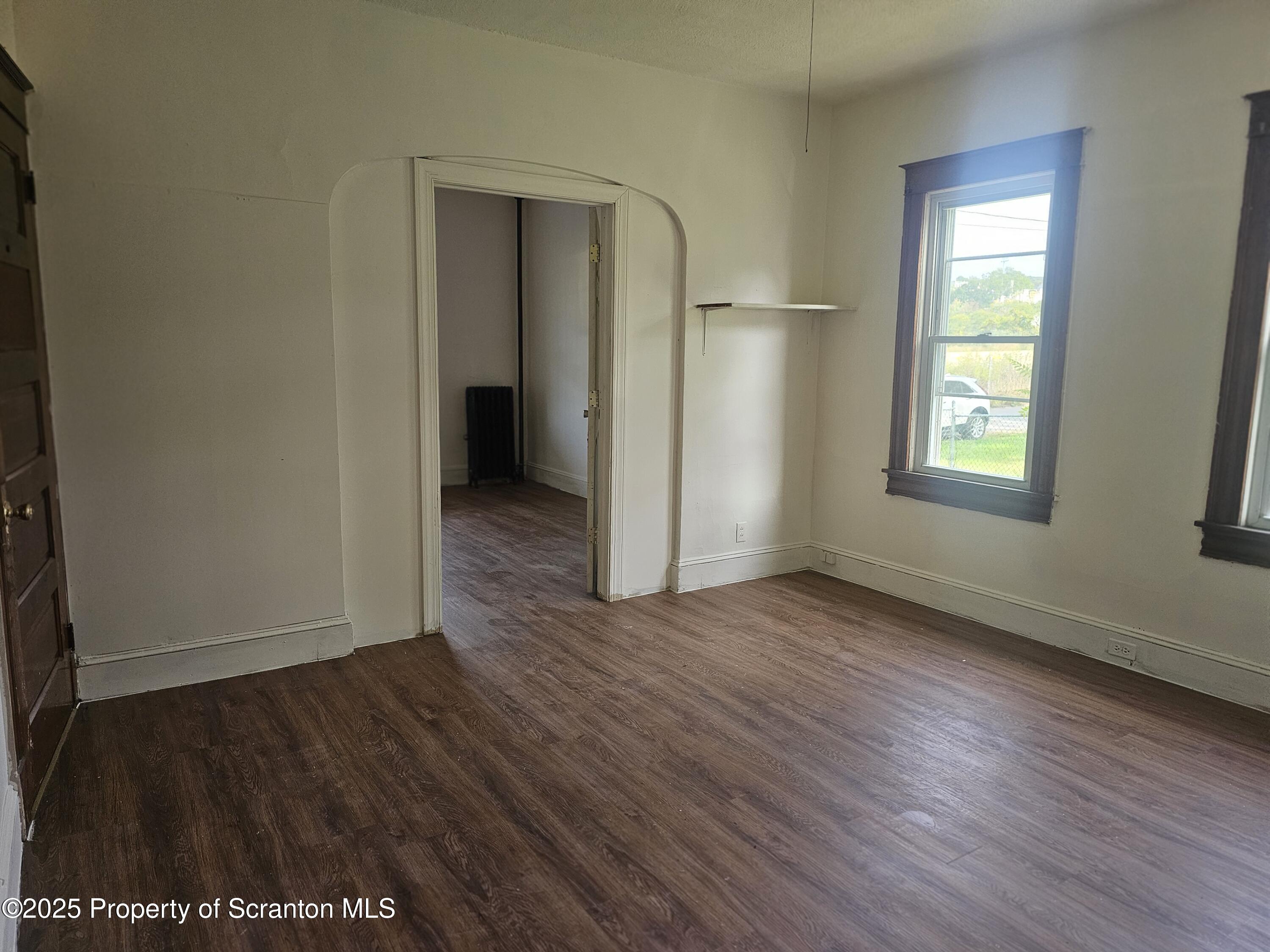 510 Front Street, Unit 1W Scranton, PA 18505 - Photo 2 of 4 an empty room with wooden floor and windows
