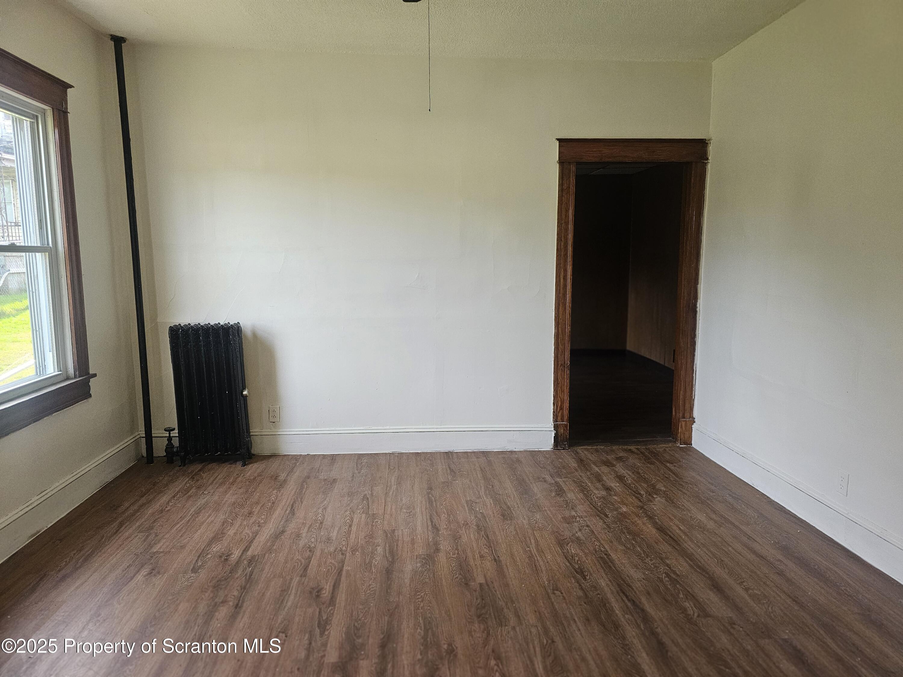 510 Front Street, Unit 1W Scranton, PA 18505 - Photo 3 of 4 an empty room with wooden floor and windows