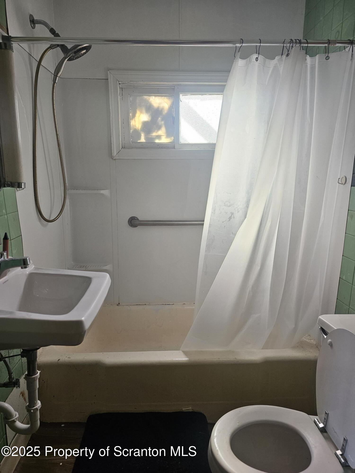 510 Front Street, Unit 1W Scranton, PA 18505 - Photo 4 of 4 a bathroom with a sink a toilet and a shower