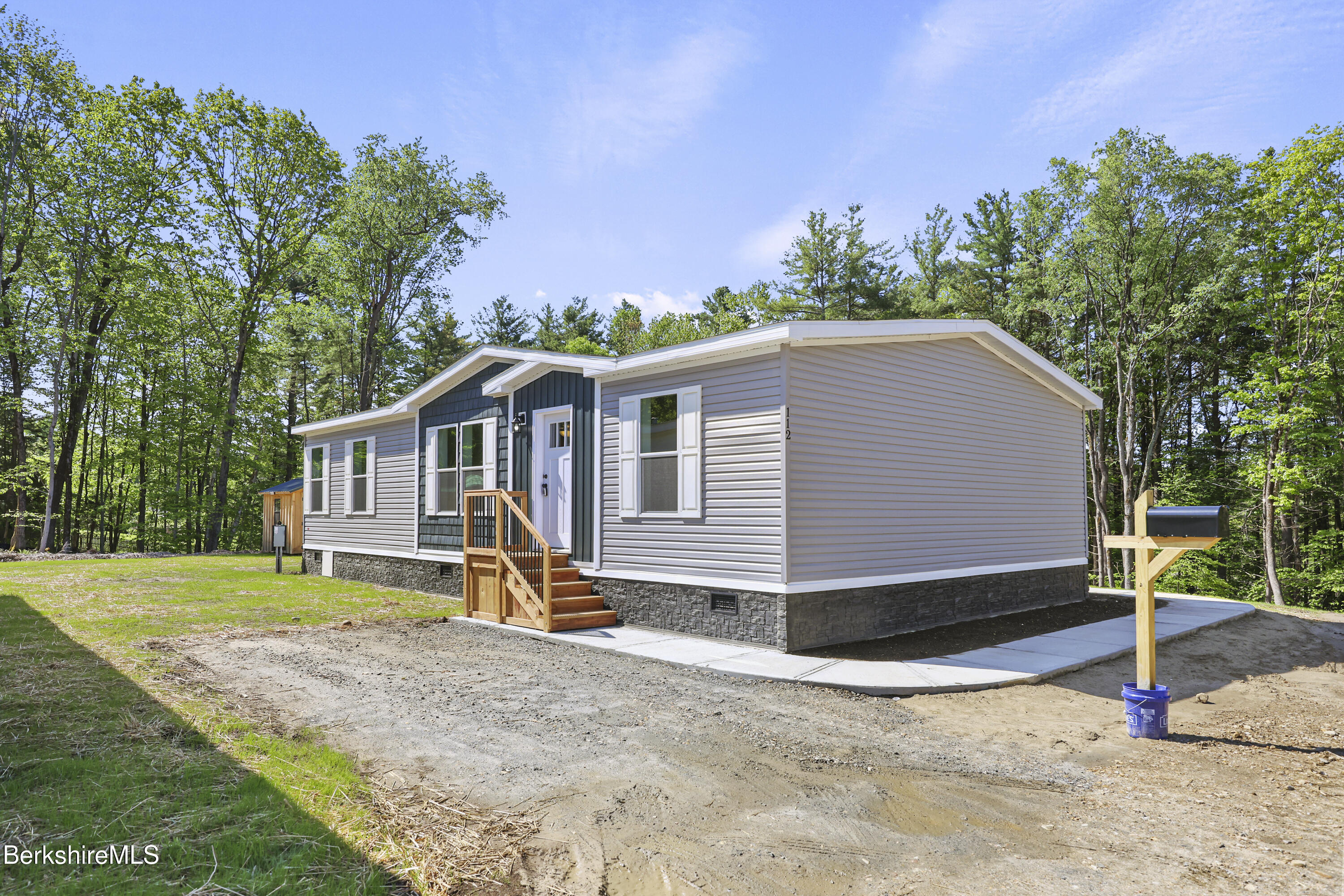 395 Cheshire Road, Unit 112 Pittsfield, MA 01201 - Photo 1 of 32 a view of a house with backyard and trees