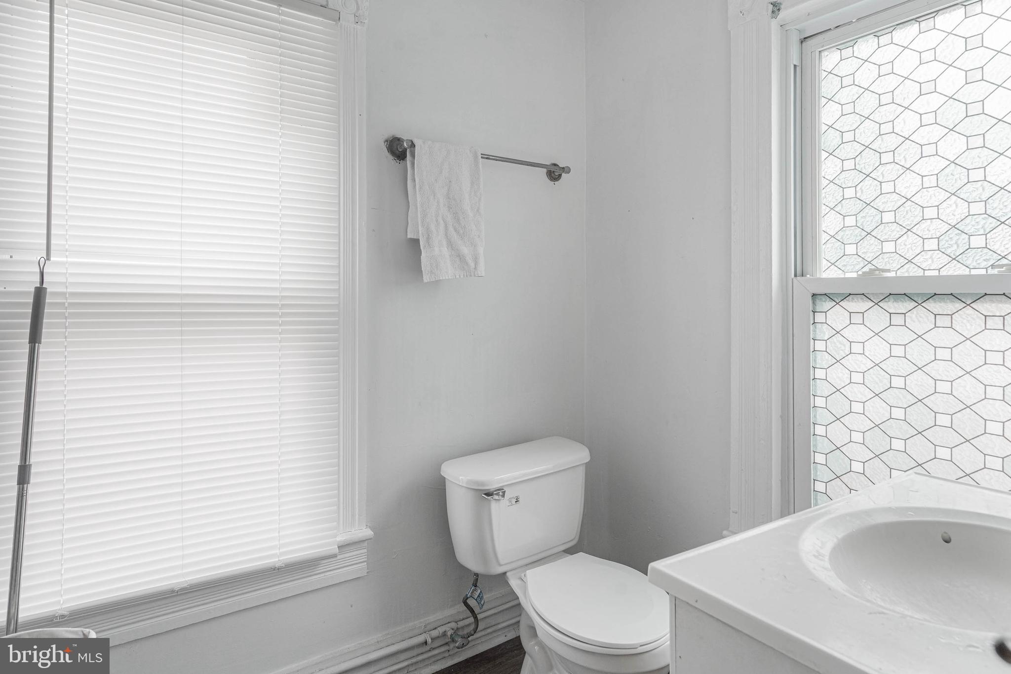 412 East State Street Delmar, MD 21875 - Photo 25 of 36 a white toilet sitting next to a bathroom sink