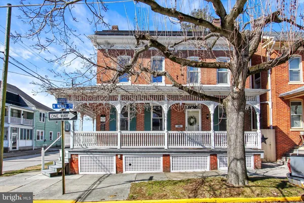 a front view of a building with a fountain