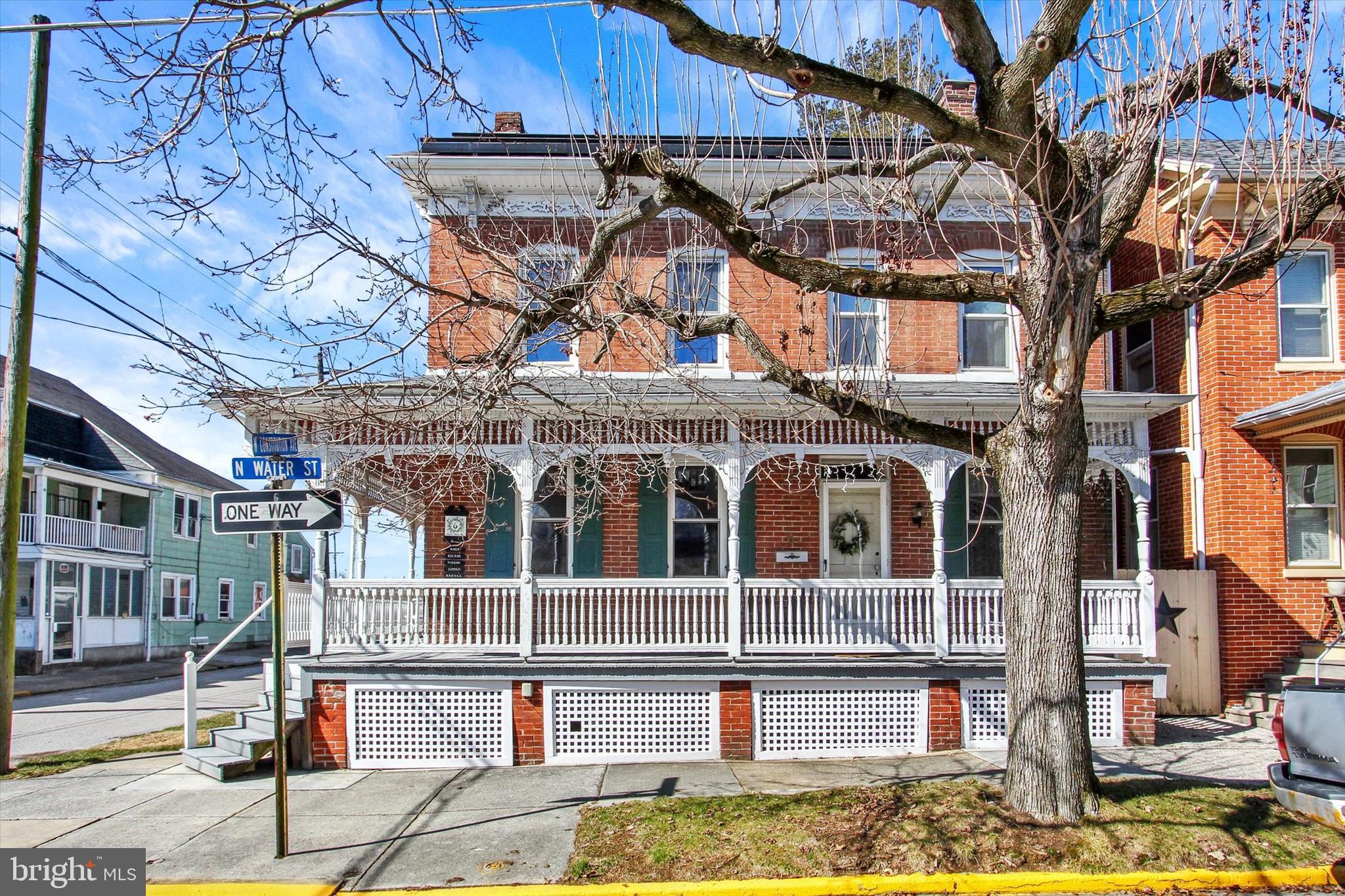 a front view of a building with a fountain