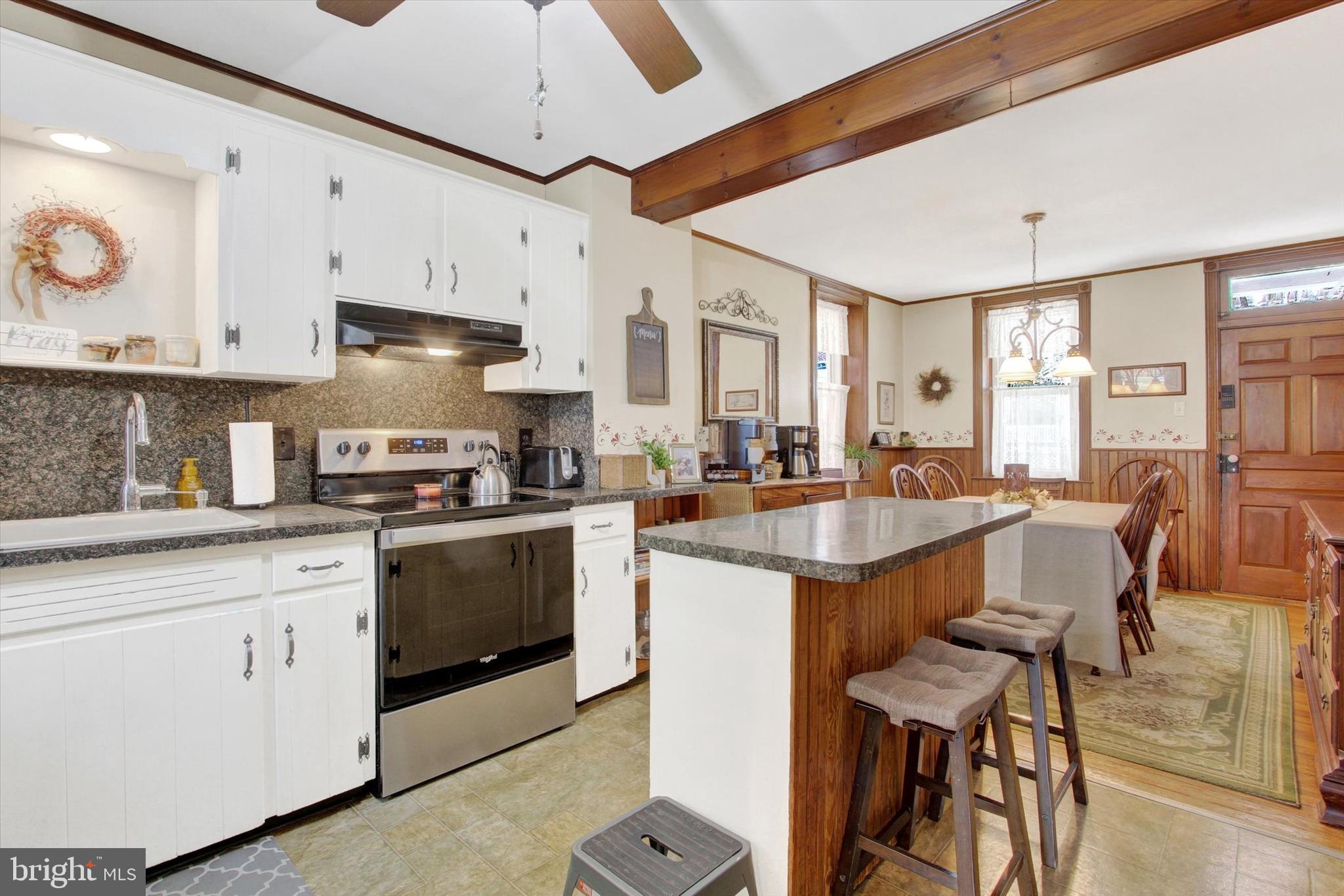 6 North Water Street Spring Grove, PA 17362 - Photo 7 of 37 a kitchen with stainless steel appliances granite countertop a stove a sink dishwasher and a refrigerator with wooden cabinets