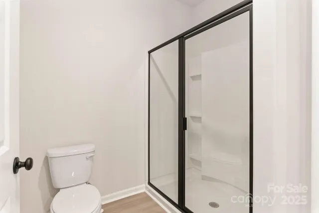 a bathroom with a toilet and a shower