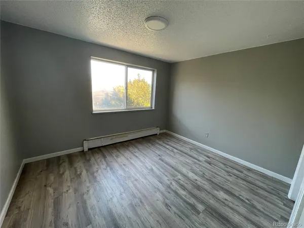 a view of hallway with wooden floor