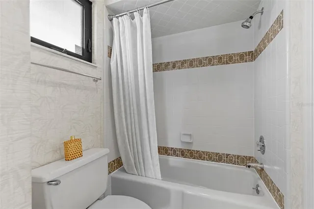 a bathroom with a tub and a shower