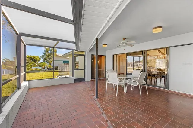 a view of a big room with wooden floor and windows