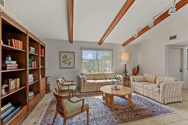 a living room with furniture and a book shelf