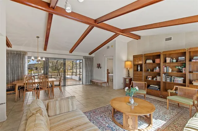 a living room with furniture and a floor to ceiling window