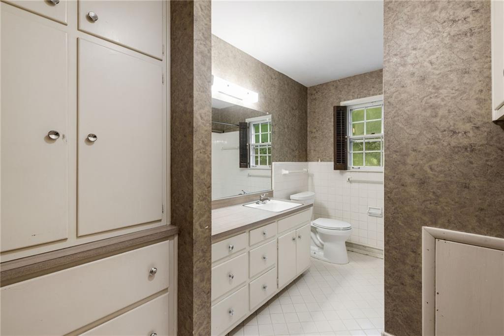 1911 Alderbrook Road Northeast Atlanta, GA 30345 - Photo 21 of 33 a bathroom with a toilet sink and mirror