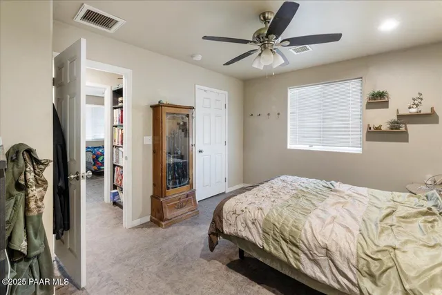 a bedroom with a bed and a ceiling fan