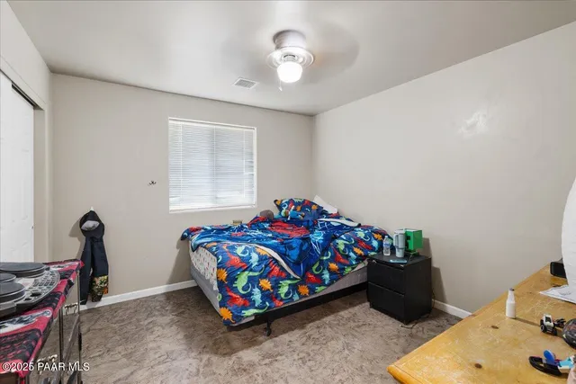 a bedroom with furniture and a window