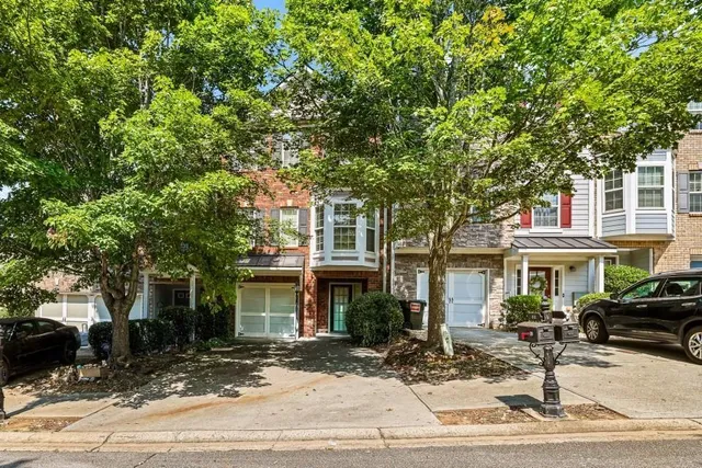 a front view of a house with a tree