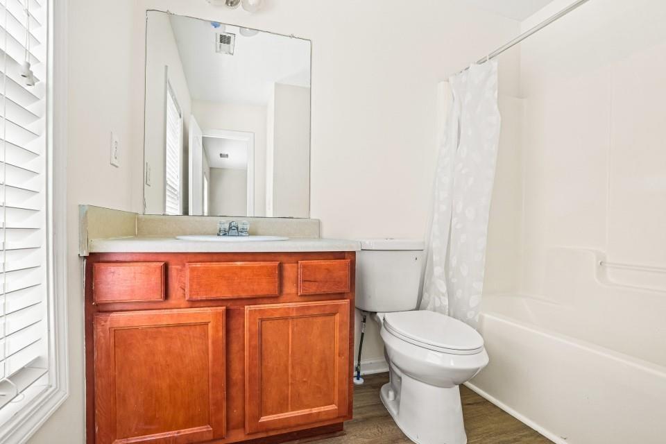 810 Ash Street Canton, GA 30114 - Photo 16 of 16 a bathroom with a toilet a sink and a bathtub