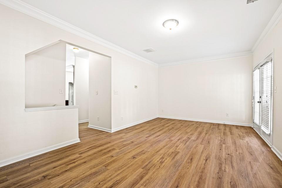 810 Ash Street Canton, GA 30114 - Photo 2 of 16 an empty room with wooden floor and windows