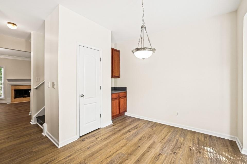 810 Ash Street Canton, GA 30114 - Photo 6 of 16 a view of a room with wooden floor and a ceiling fan