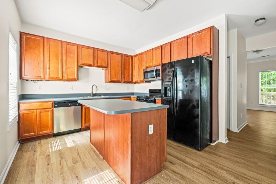 810 Ash Street Canton, GA 30114 - Photo 8 of 16 a kitchen with stainless steel appliances granite countertop a refrigerator a sink and wooden cabinets