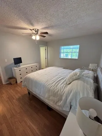 a bedroom with a bed and a ceiling fan