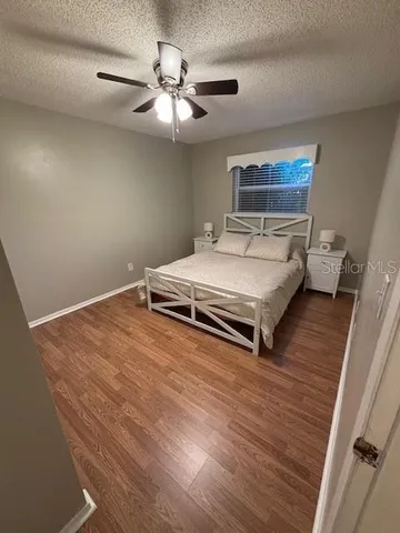 a spacious bedroom with a bed and a chandelier