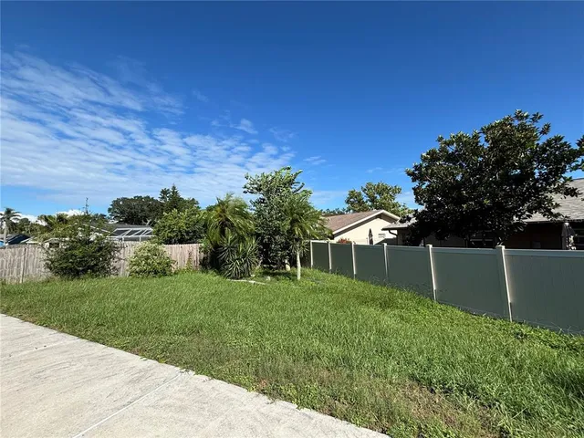 a view of a backyard with plants and a backyard