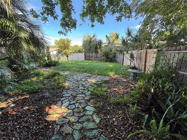 a backyard of a house with lots of green space
