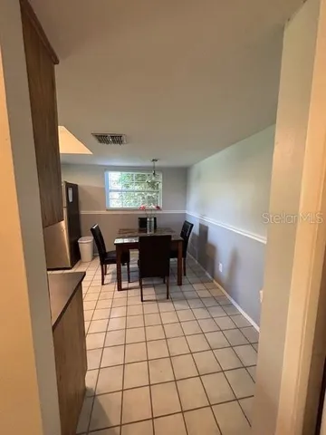 a view of a dining room with furniture and chandelier