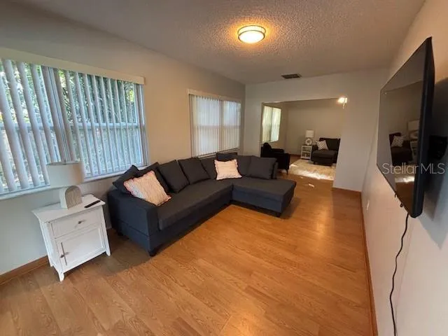a living room with furniture window and flat screen tv