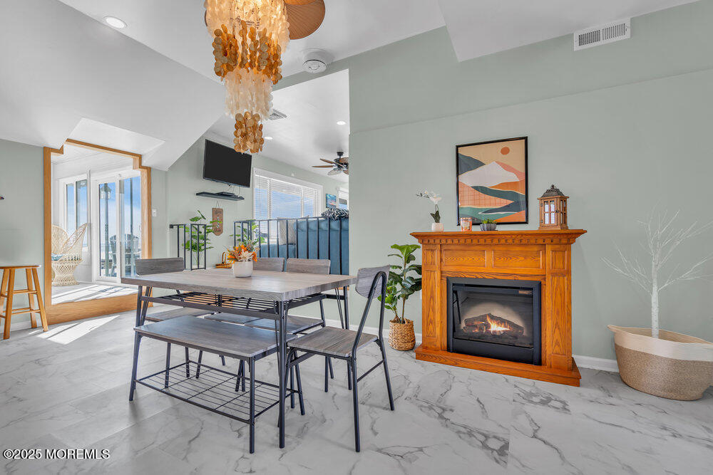 1604 Beach Boulevard Forked River, NJ 08731 - Photo 18 of 108 a dining room with furniture and a fireplace
