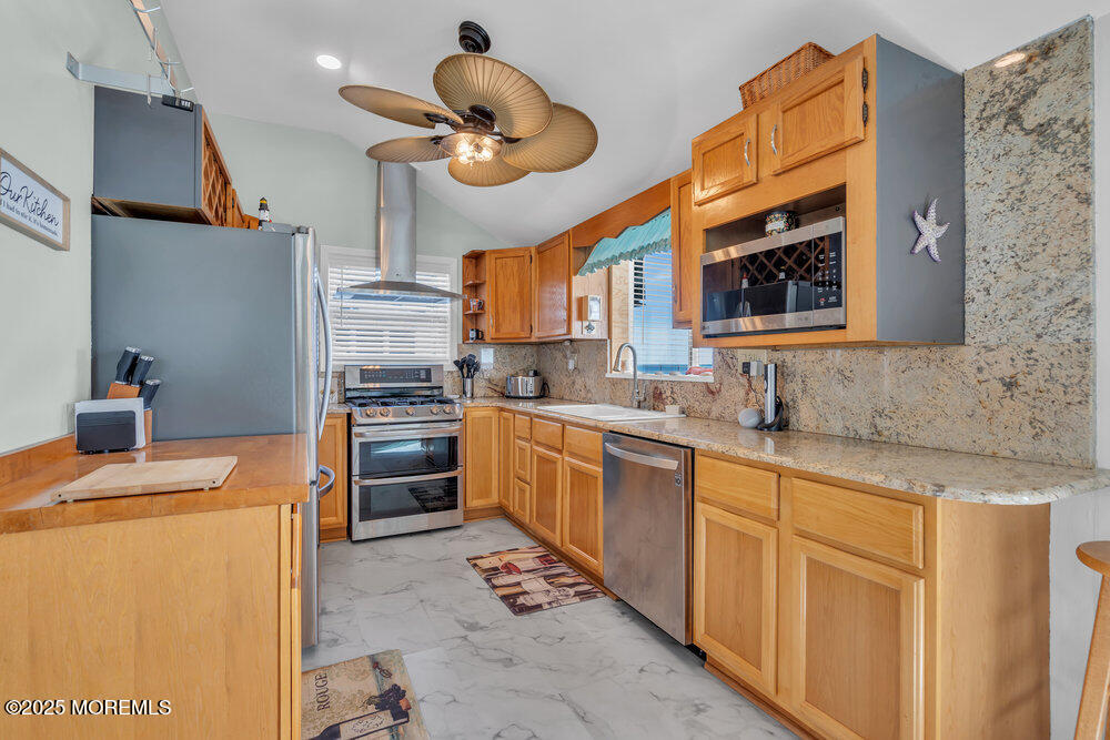 1604 Beach Boulevard Forked River, NJ 08731 - Photo 23 of 108 a kitchen with stainless steel appliances granite countertop a sink a stove and a refrigerator