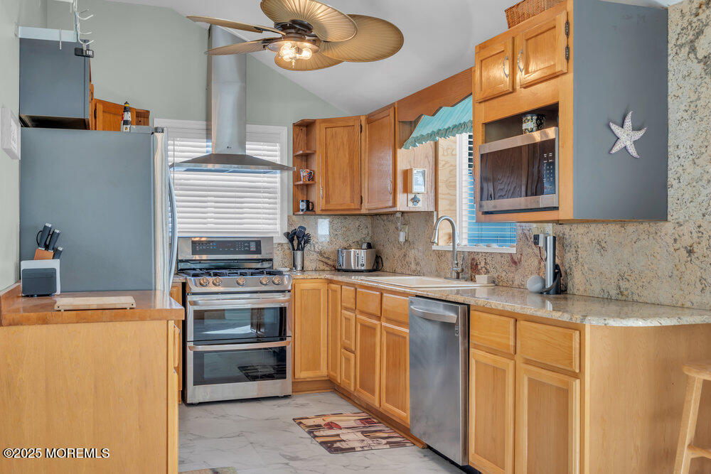 1604 Beach Boulevard Forked River, NJ 08731 - Photo 24 of 108 a kitchen with stainless steel appliances granite countertop a sink stove and refrigerator